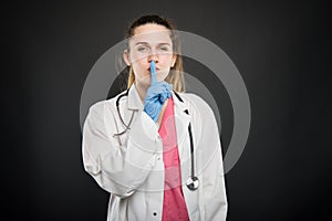 Young doctor portrait holding making sush gesture