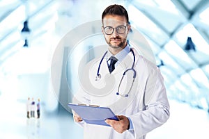 Young doctor portrait while standing in the hospital foyer