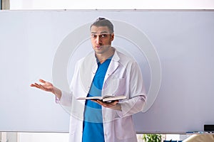 Young male doctor in presentation concept