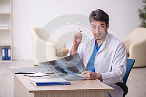 Young doctor radiologist sitting at the hospital