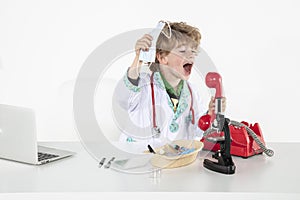Young doctor screams into headphones during a telephone conversation