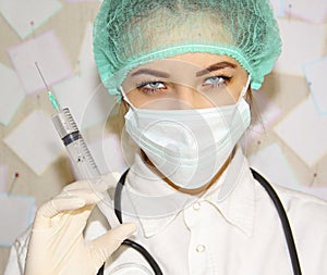 Young doctor with a syringe preparing to inject photo