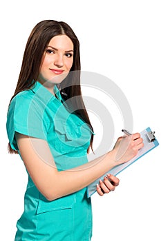 Young doctor in uniform with clipboard writing