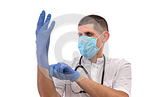 Young doctor in uniform getting ready to work putting on gloves isolated on a white background