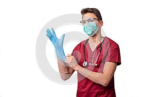 young doctor in uniform getting ready to work putting on gloves isolated on a white background