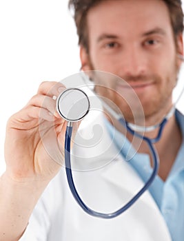 Young doctor using stethoscope smiling
