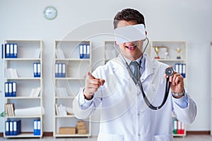 Young doctor with vr virtual reality headset working in the offi