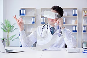 Young doctor with vr virtual reality headset working in the offi