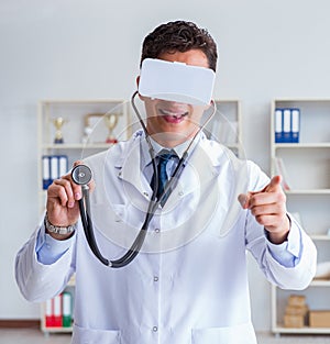 Young doctor with vr virtual reality headset working in the offi