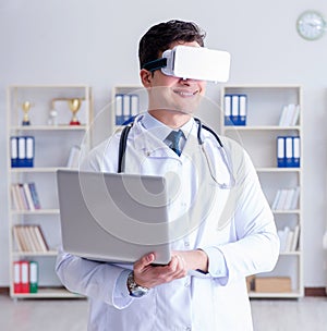 Young doctor with vr virtual reality headset working in the offi