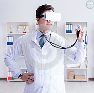 Young doctor with vr virtual reality headset working in the offi