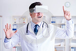 Young doctor with vr virtual reality headset working in the offi