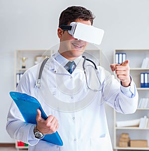 Young doctor with vr virtual reality headset working in the offi