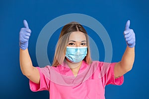 Young doctor wearing a mask face and a pink uniform