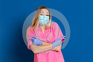 Young doctor wearing a mask face and a pink uniform