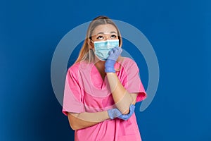 Young doctor wearing a mask face and a pink uniform