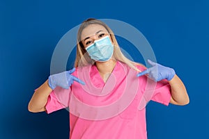 Young doctor wearing a mask face and a pink uniform