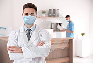 Young doctor wearing medical mask in clinic