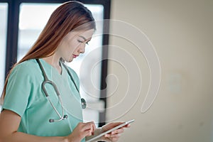 Young doctor woman smile face with stethoscope looking tablet co