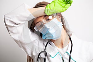 Young doctor woman tired after work at her workplace