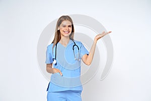 Young doctor woman wearing a stethoscope and showing open hand palm with copy space for product isolated on white background