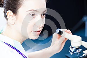 Young doctor working with microscope