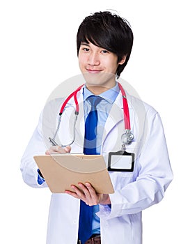 Young doctor write on clipboard