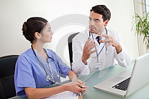 Young doctors working with a laptop