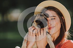 Young dogs owner is gently hugging her pet