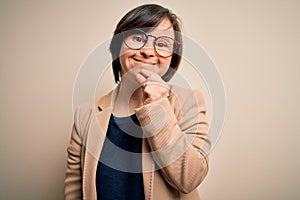 Young down syndrome business woman wearing glasses standing over isolated background looking confident at the camera with smile