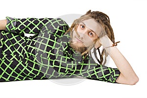 Young dreadlock man lies isolated