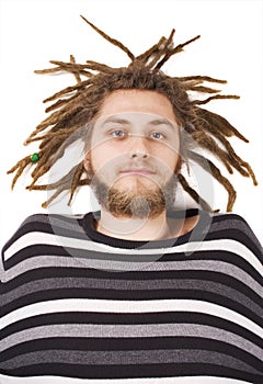 Young dreadlock man lies isolated photo