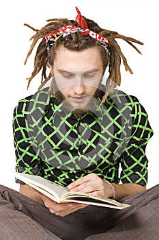 Young dreadlock man reading book isolated photo