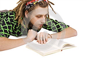 Young dreadlock man reading book isolated photo