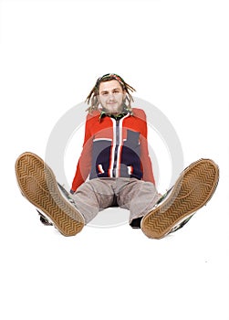 Young dreadlock man sits isolated photo