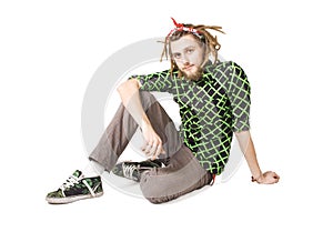 Young dreadlock man sits isolated photo