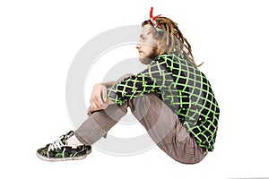 Young dreadlock man sits isolated photo