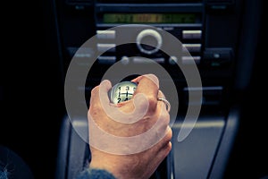 A driver in a car performs tasks necessary to steer the vehicle