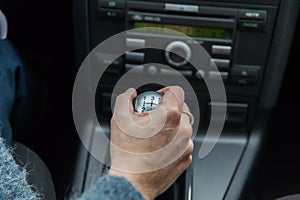 A driver in a car performs tasks necessary to steer the vehicle