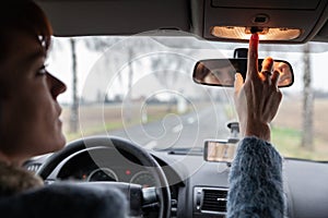 A driver in a car performs tasks necessary to steer the vehicle