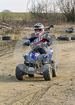 A young driver trains a ride on a small quad.