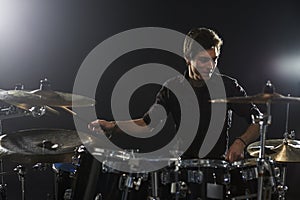 Young Drummer Playing Drum Kit In Studio