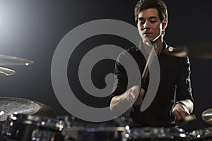 Young Drummer Playing Drum Kit In Studio