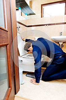 Young drunk or sick man vomiting