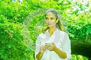 Young East Indian American Woman texting on cell phone outdoor at Central Park, New York