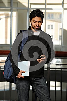 Young Eastern student with cell phone