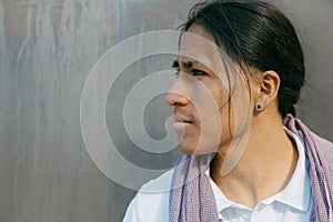 Young ecuadorian man portrait against titanium background, copy space
