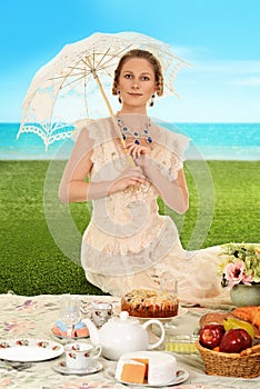 Young edwardian woman at picnic with umbrella