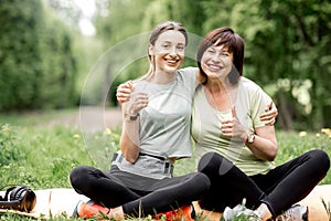 Young and elder woman doing yoga in the park