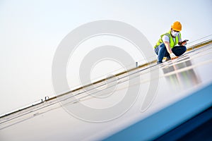 Young electrical engineer Work in a photovoltaic power plant Checking solar panel quality And control the electricity in the